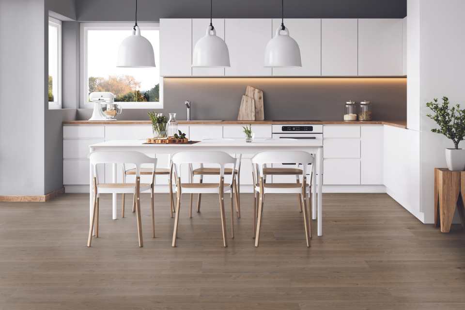 wood look luxury vinyl in all white modern kitchen with greenery